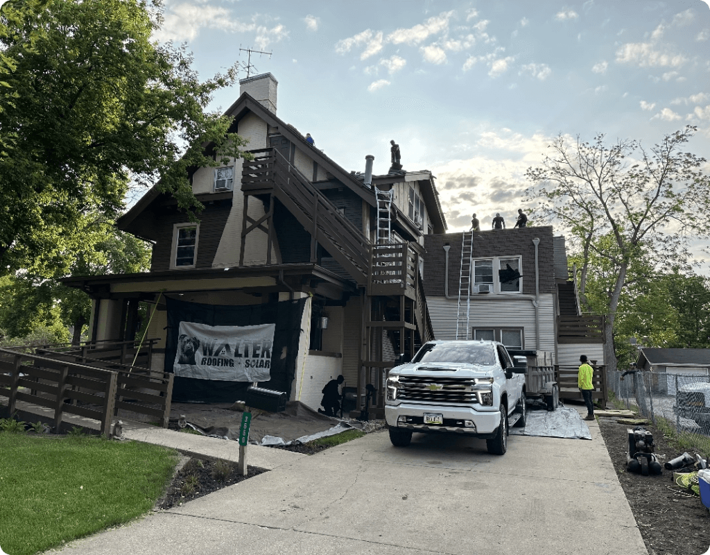 Walter Roofing + Solar crew members replace roof of sober living house
