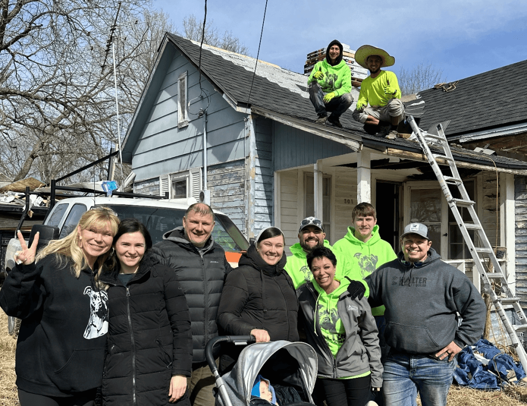 Walter Roofing + Solar team poses with client/family from KCCI new story