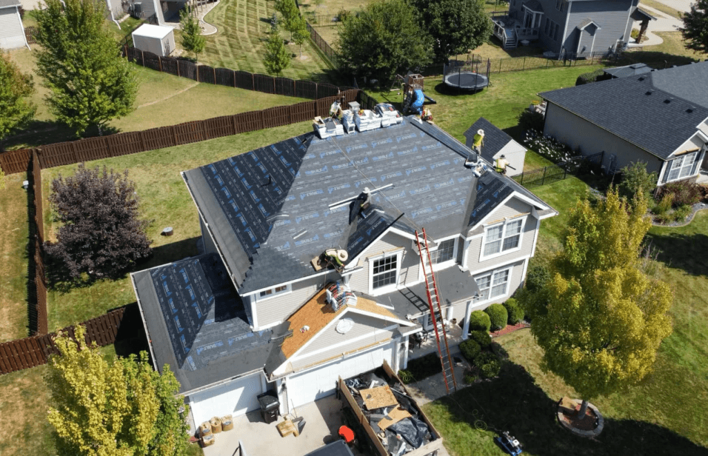 house in a suburb with roof being repaired by Walter Roofing + Solar team